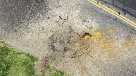 A US bomb from World War II explodes at a Japanese airport, causing a large crater in a taxiway