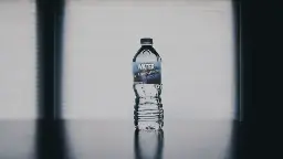 A water bottle labelled with "De-Estrogenized Water, 0.5% Estrogen by Volume"