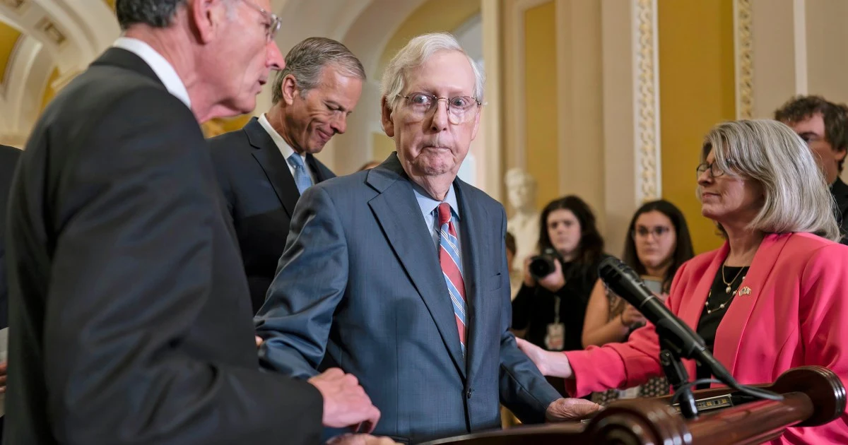 Mitch McConnell escorted away from cameras after freezing  during a news conference