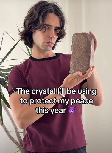 A phot of a person holding a brick with the caption “ The crystal I’ll be using to protect my peace this year”