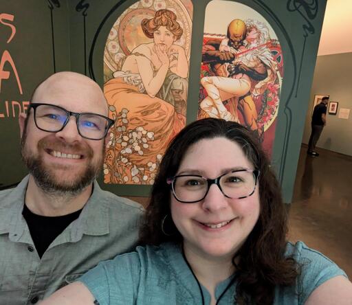 Couple in front of Mucha exhibit 