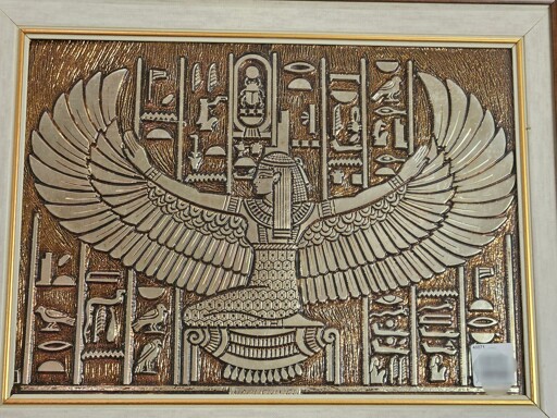 A picture depicting ancient Egyptian hieroglyphs and a person with bird wings.