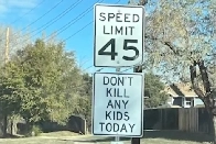 Person put up signs tell people not to kill people with cars. Police say that's criminal tampering.